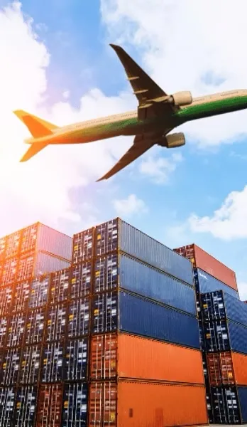 Airplane flying over shipping containers