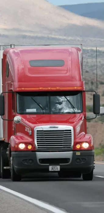 Red truck driving on highway